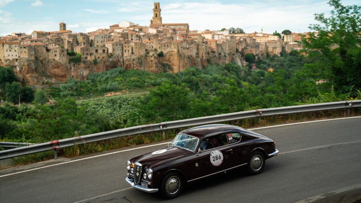 A 1954 Lancia Aurelia B20 GT 2500 Berlinetta Pinin Farina drives past the Tuscan town of Pitigliano © Chopard